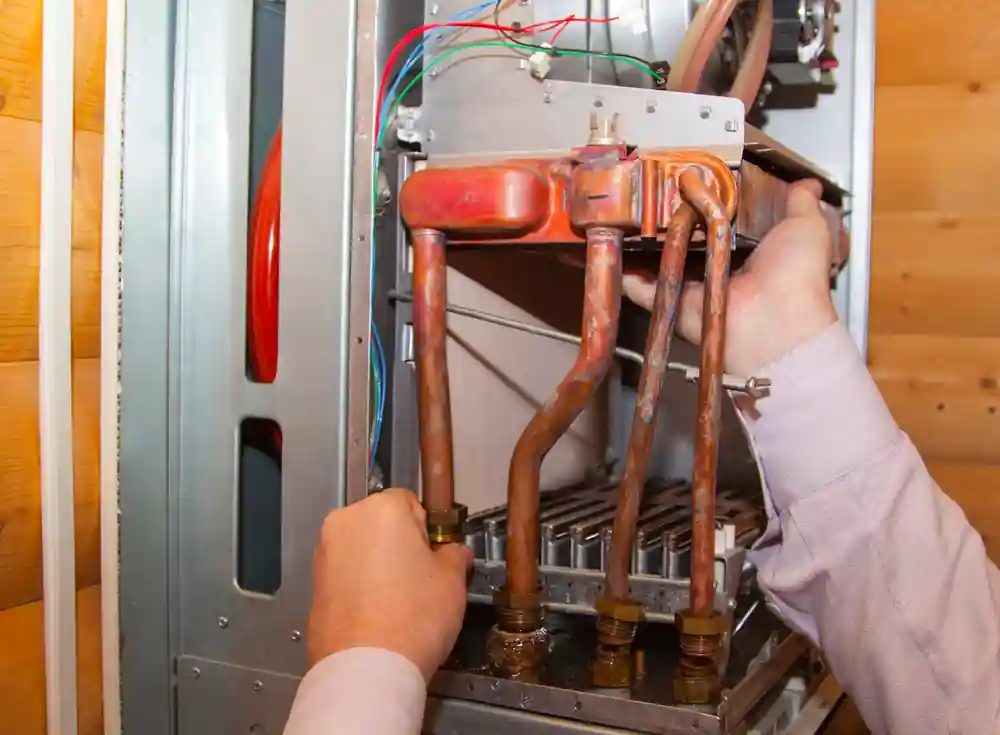quikplumbing-tank-vs-tankless-water-heater-greenville-sc inside water heater with connections and wiring