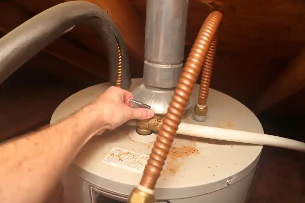 plumber checks water heater for repairs
